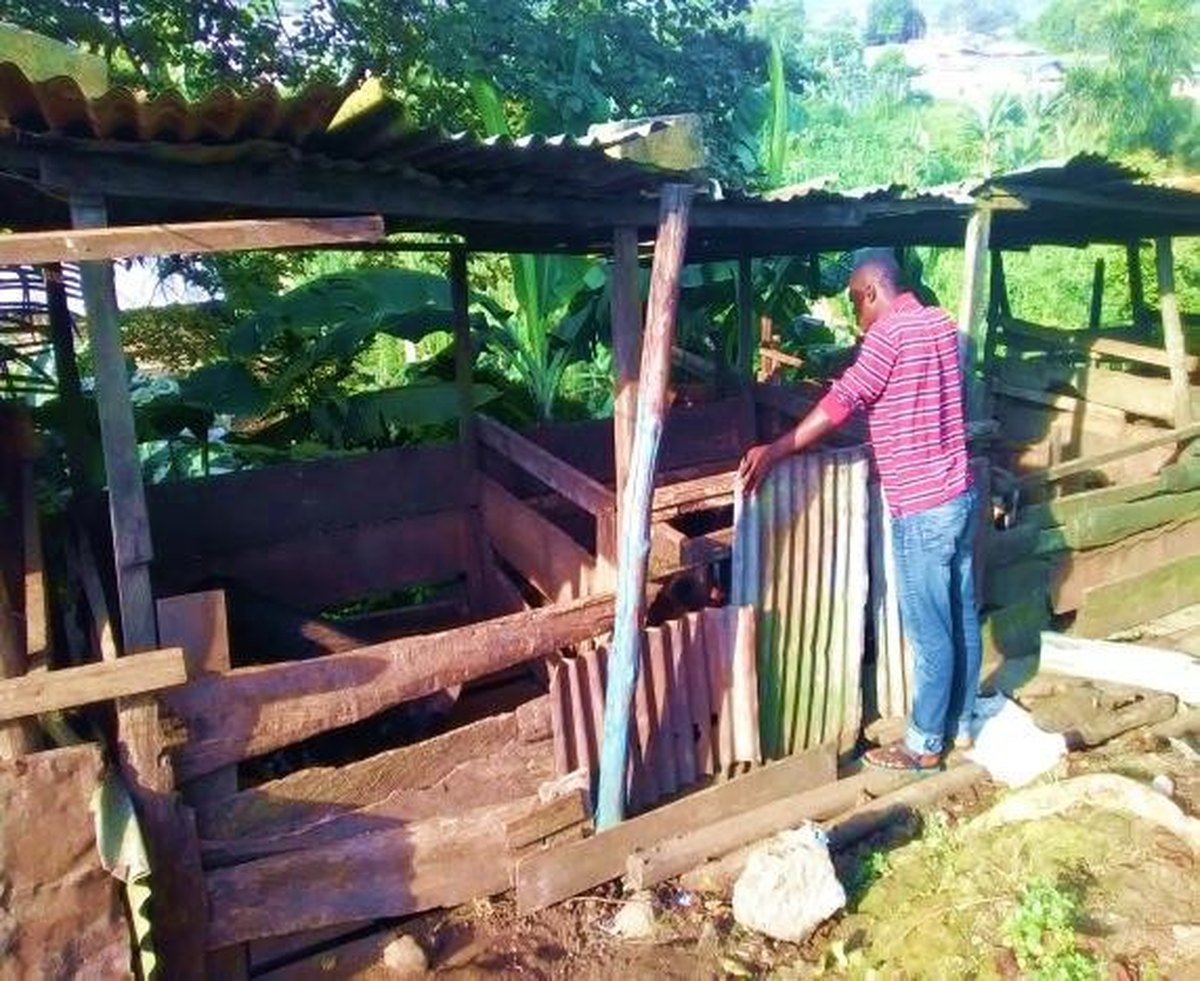Community member building a livestock pen